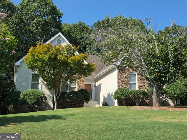 a front view of a house with a yard