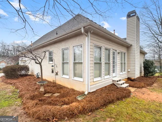 a view of a house with a yard covered with snow in the background