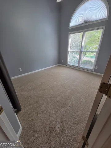 en empty room with windows and stairs