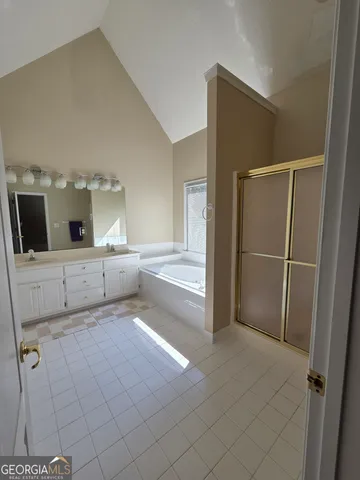 a living room with furniture a fireplace and a large window