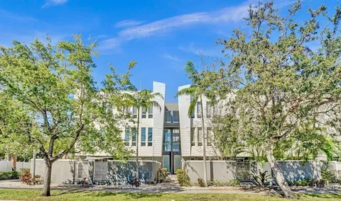 a view of a building with a tree in front of it