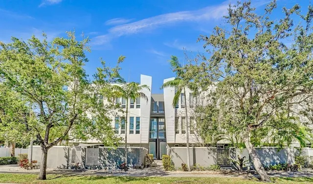 a view of a building with a tree in front of it