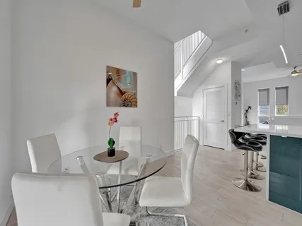 a dining room with furniture and wooden floor