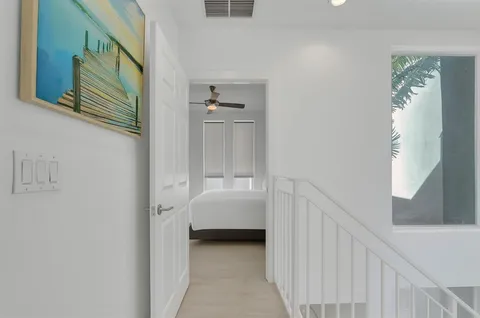 a view of a hallway with a white walls and stairs