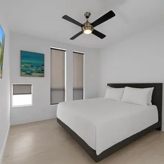 a large bed sitting in a bedroom next to a window