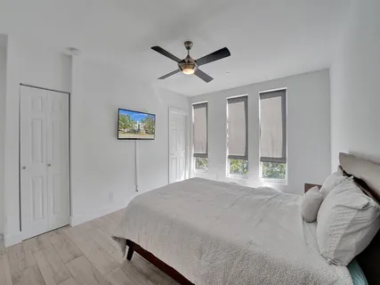 a bedroom with a bed rug and window
