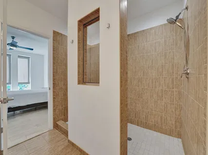 a bathroom with a shower and toilet