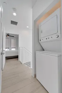 a view of a closet area with wooden floor