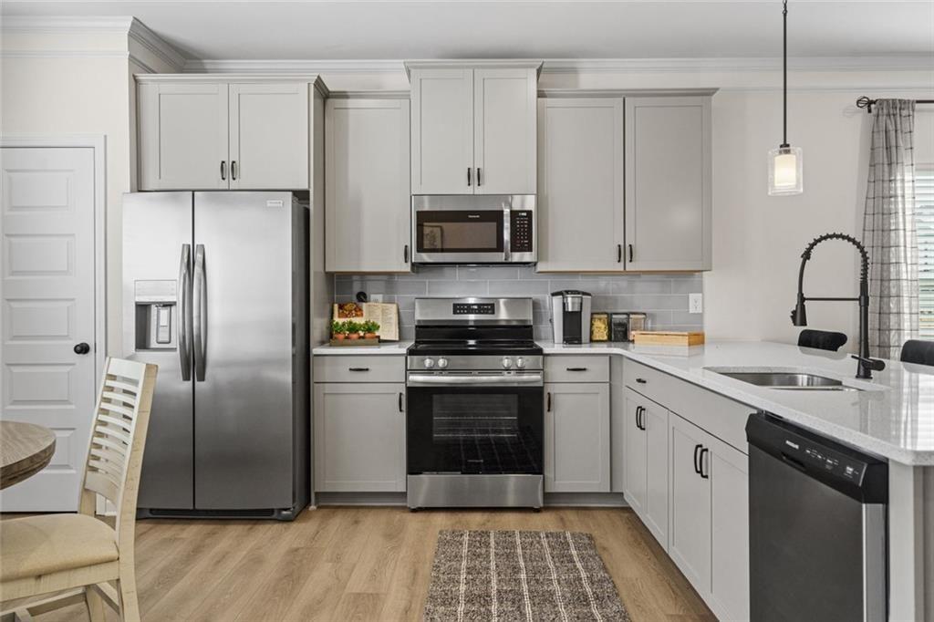 312 Caroline Place, Unit 99 Villa Rica, GA 30180 - Photo 11 of 24 a kitchen with stainless steel appliances granite countertop a refrigerator sink and stove