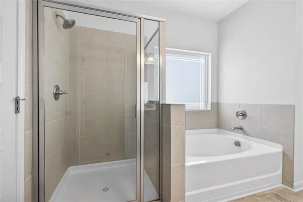 a bathroom with a bathtub and a shower