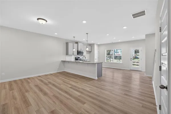 a view of kitchen with wooden floor and window
