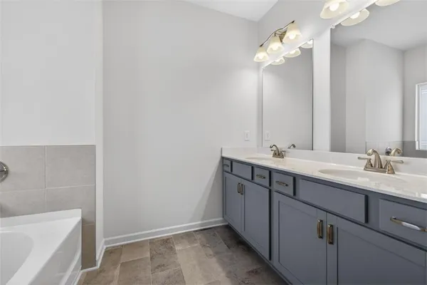a bathroom with a double vanity sink and a mirror