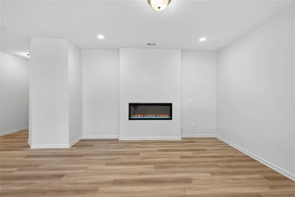 a view of a room with wooden floor and white wall