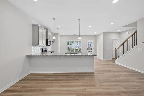 a view of kitchen and kitchen with wooden floor