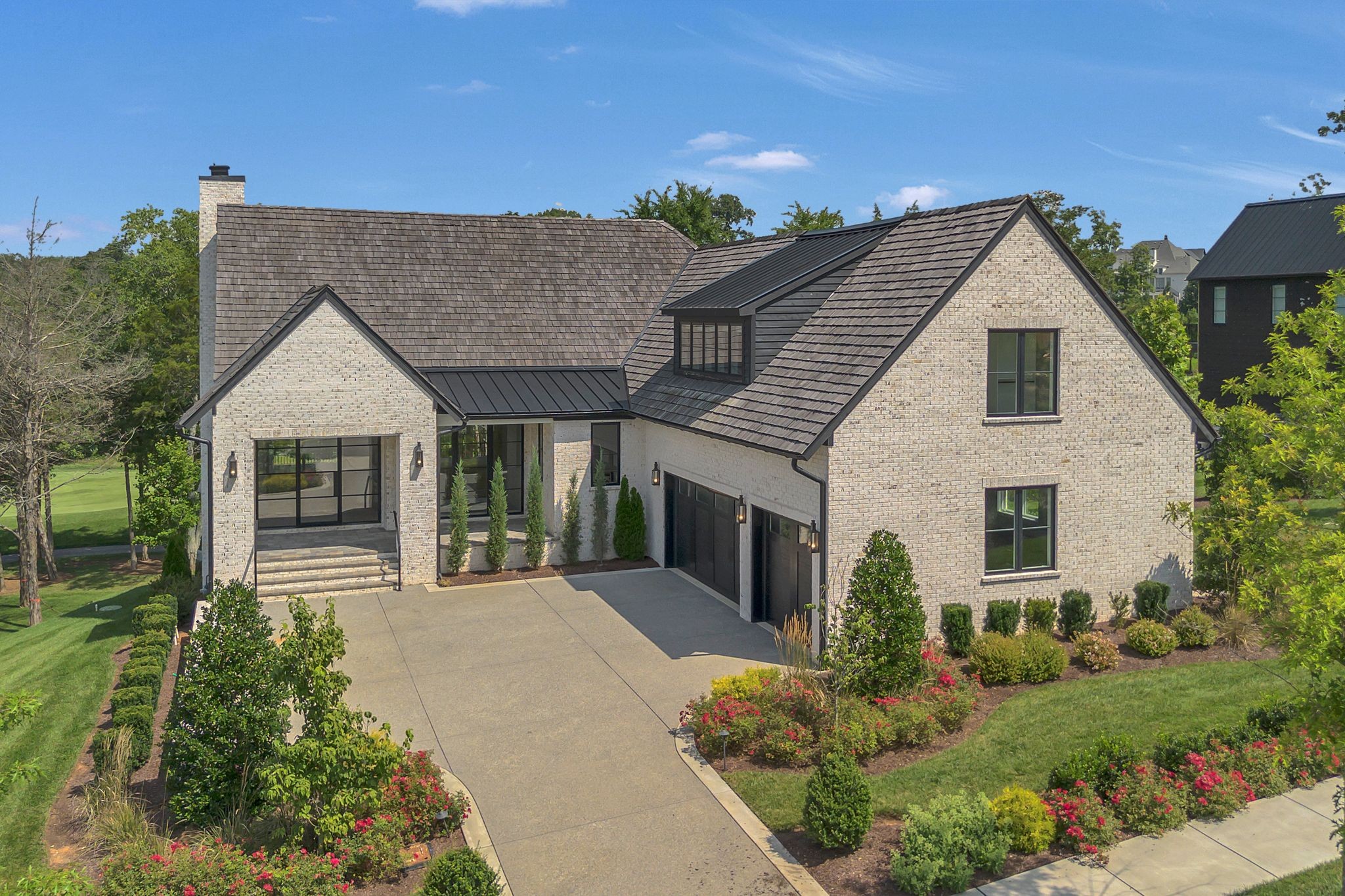 a front view of a house with a garden
