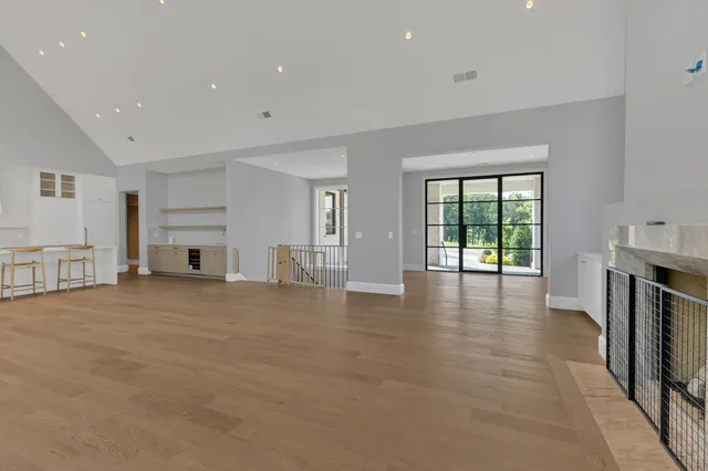 a bedroom with a large bed and a potted plant