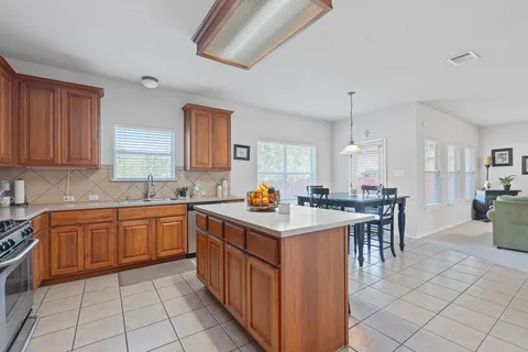 a kitchen with a sink stove and cabinets