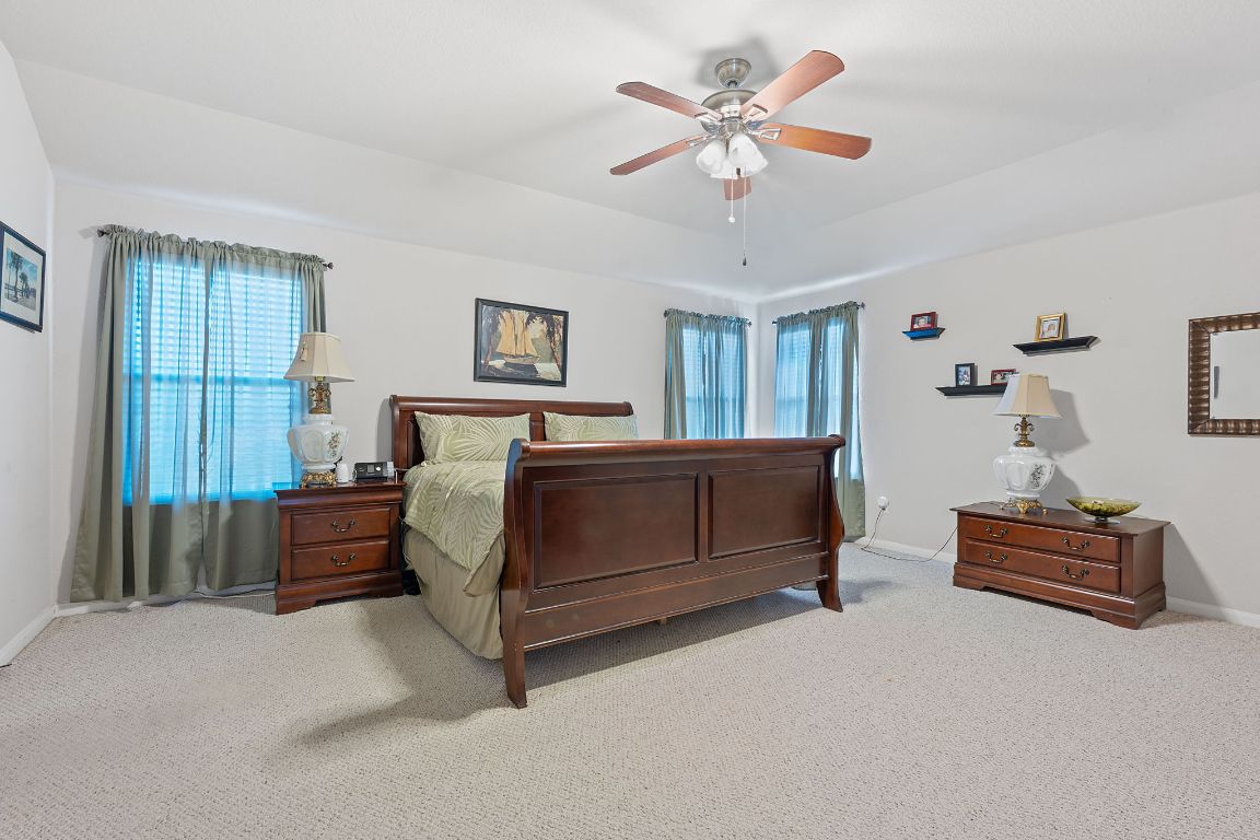 1024 Portchester Castle Path Pflugerville, TX 78660 - Photo 16 of 40 Carpeted bedroom with baseboards and a ceiling fan