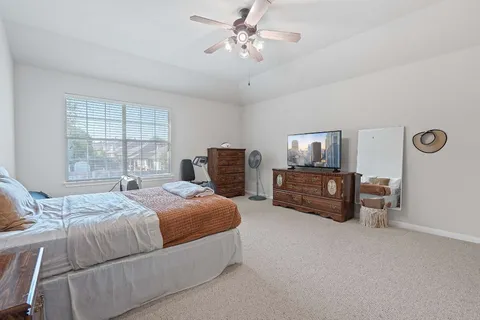 a bedroom with bed and window