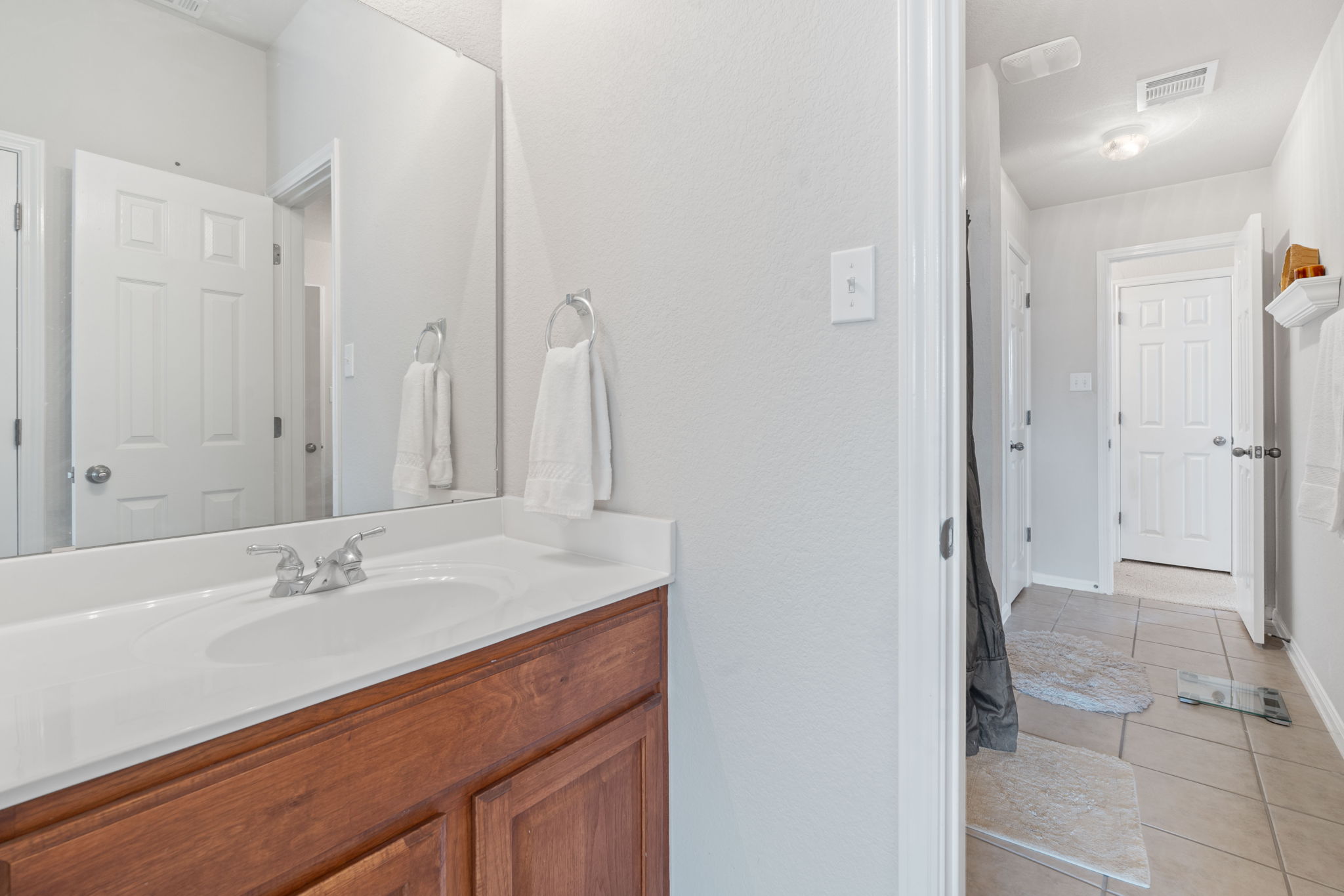 1024 Portchester Castle Path Pflugerville, TX 78660 - Photo 22 of 40 a bathroom with a sink vanity granite shower and a mirror