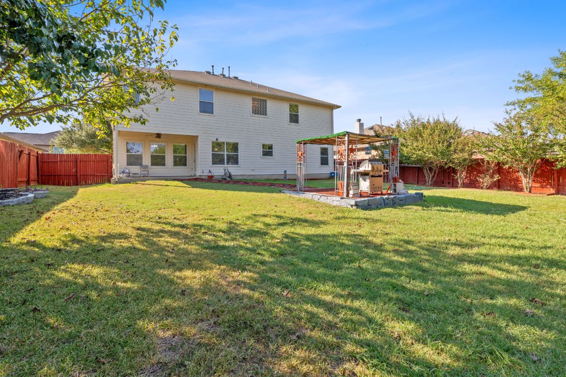 1024 Portchester Castle Path Pflugerville, TX 78660 - Photo 27 of 40 Back of house with a fenced backyard and a patio
