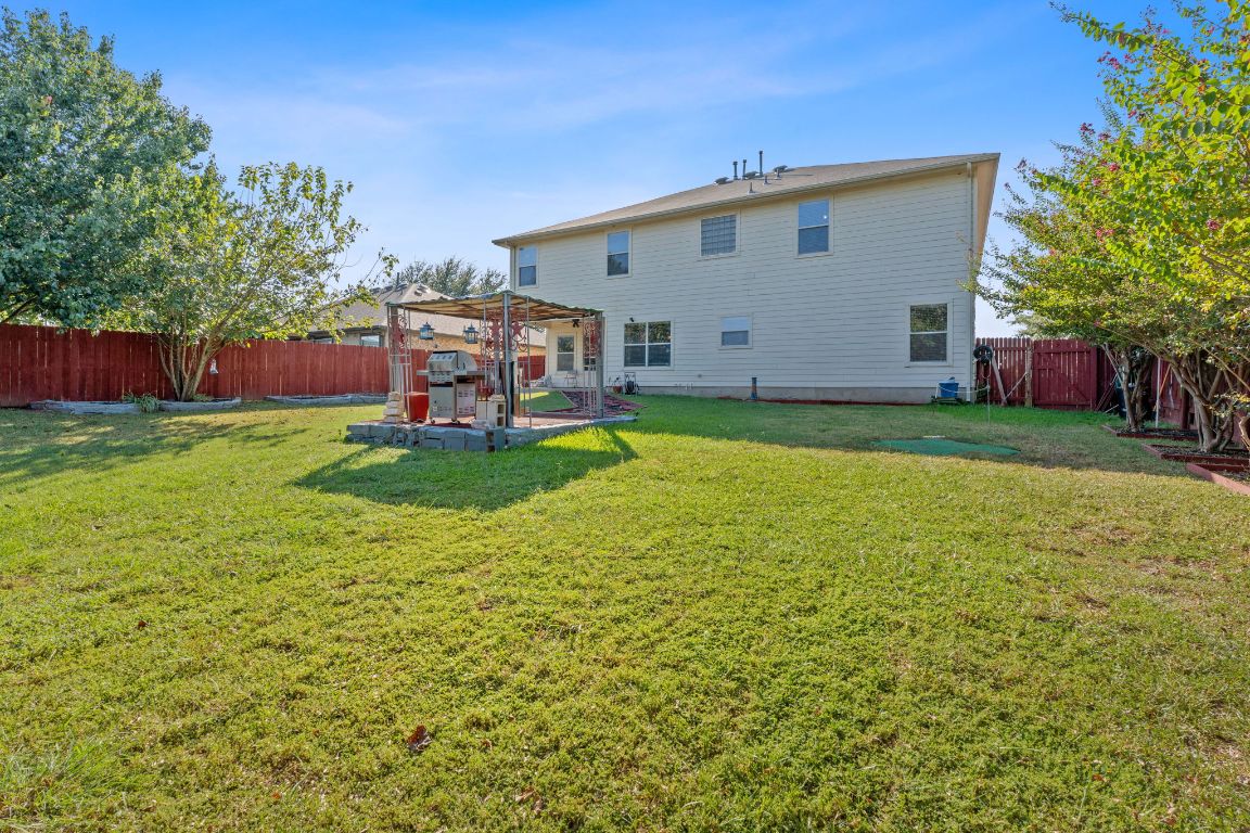 1024 Portchester Castle Path Pflugerville, TX 78660 - Photo 28 of 40 Rear view of property featuring a fenced backyard and a patio