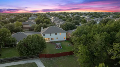 a view of a street with a yard in front of it