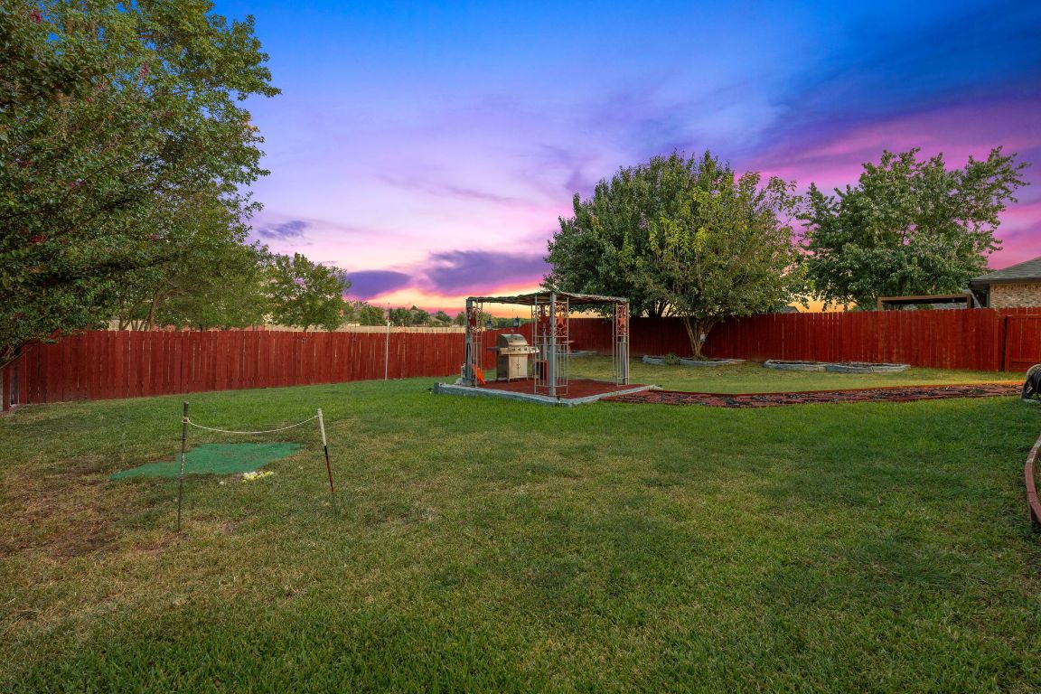 1024 Portchester Castle Path Pflugerville, TX 78660 - Photo 40 of 40 Yard at dusk with a fenced backyard and a patio area