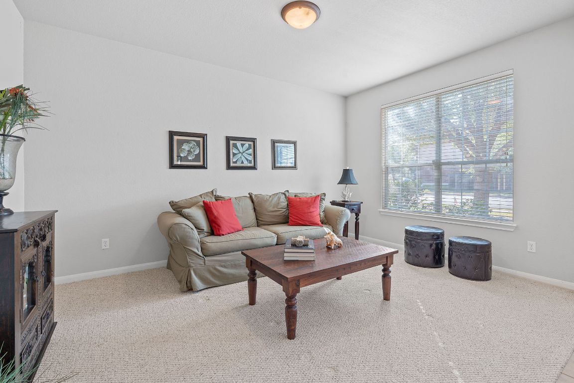 1024 Portchester Castle Path Pflugerville, TX 78660 - Photo 5 of 40 Living room featuring light carpet and baseboards
