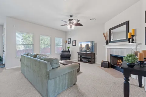 a living room with furniture a fireplace and a flat screen tv