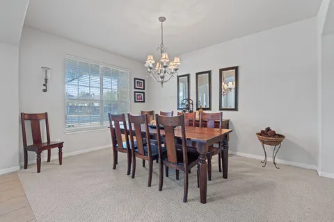 a view of a dining room with furniture and window