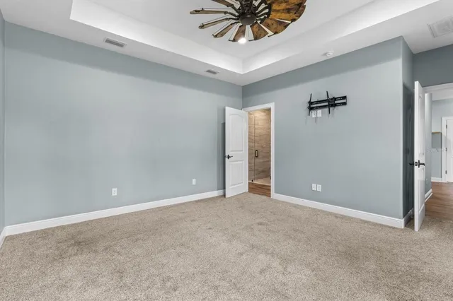a view of a room with a ceiling fan