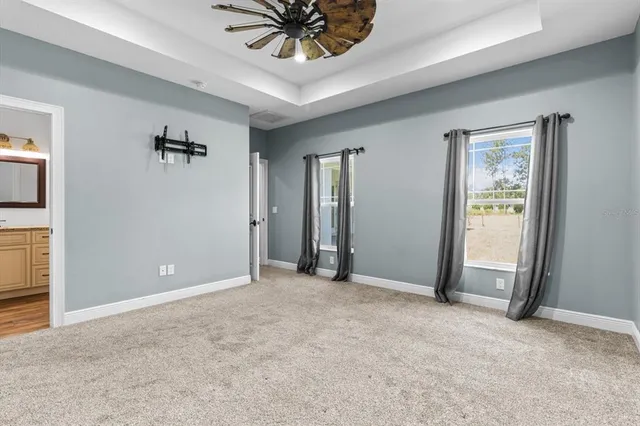 an empty room with closet and a chandelier fan