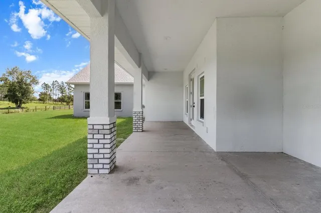 a view of a porch with couches and garden