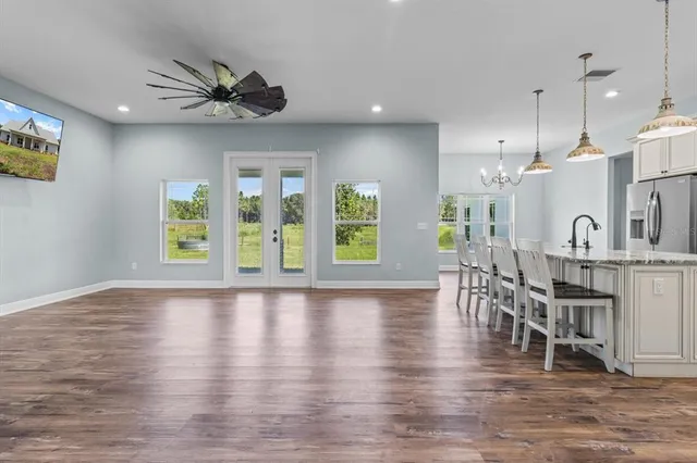 a view of a kitchen with furniture and wooden floor