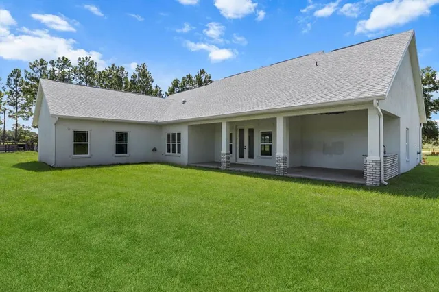 a view of a house with a backyard