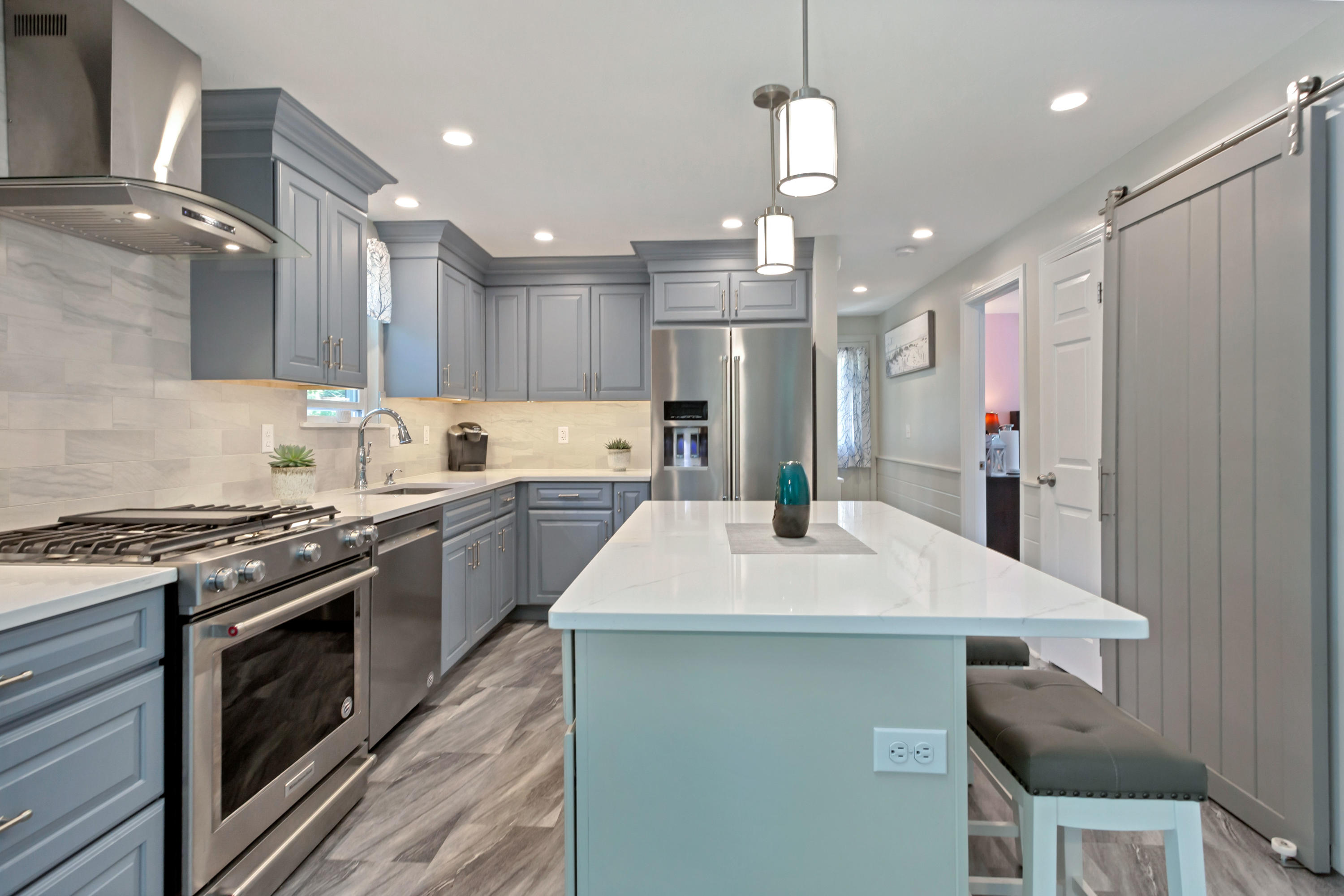 138 Gunstock Road Osterville, MA 02655 - Photo 12 of 47 a kitchen with kitchen island a sink stainless steel appliances and cabinets