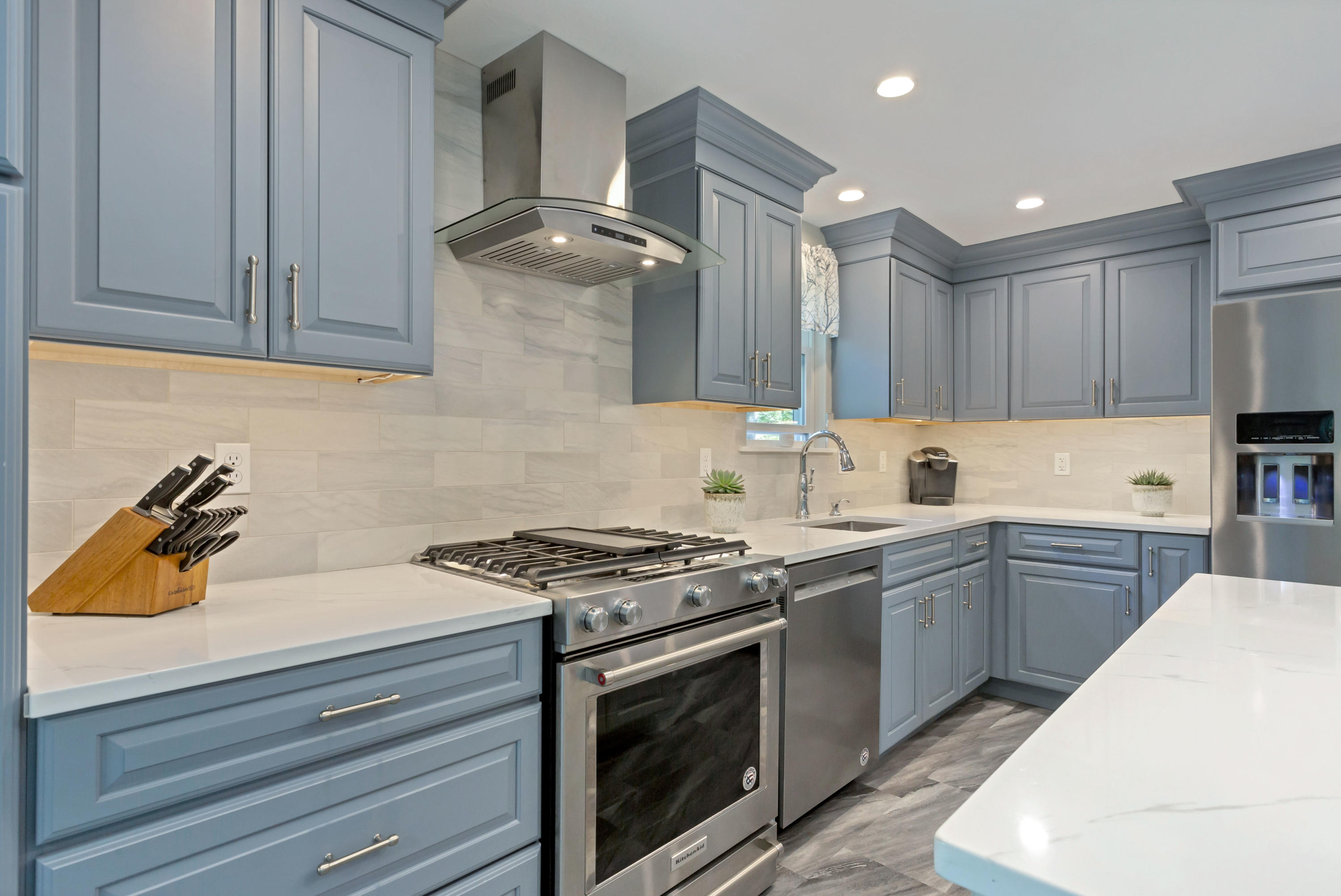 138 Gunstock Road Osterville, MA 02655 - Photo 14 of 47 a kitchen with stainless steel appliances granite countertop a stove and a white cabinets