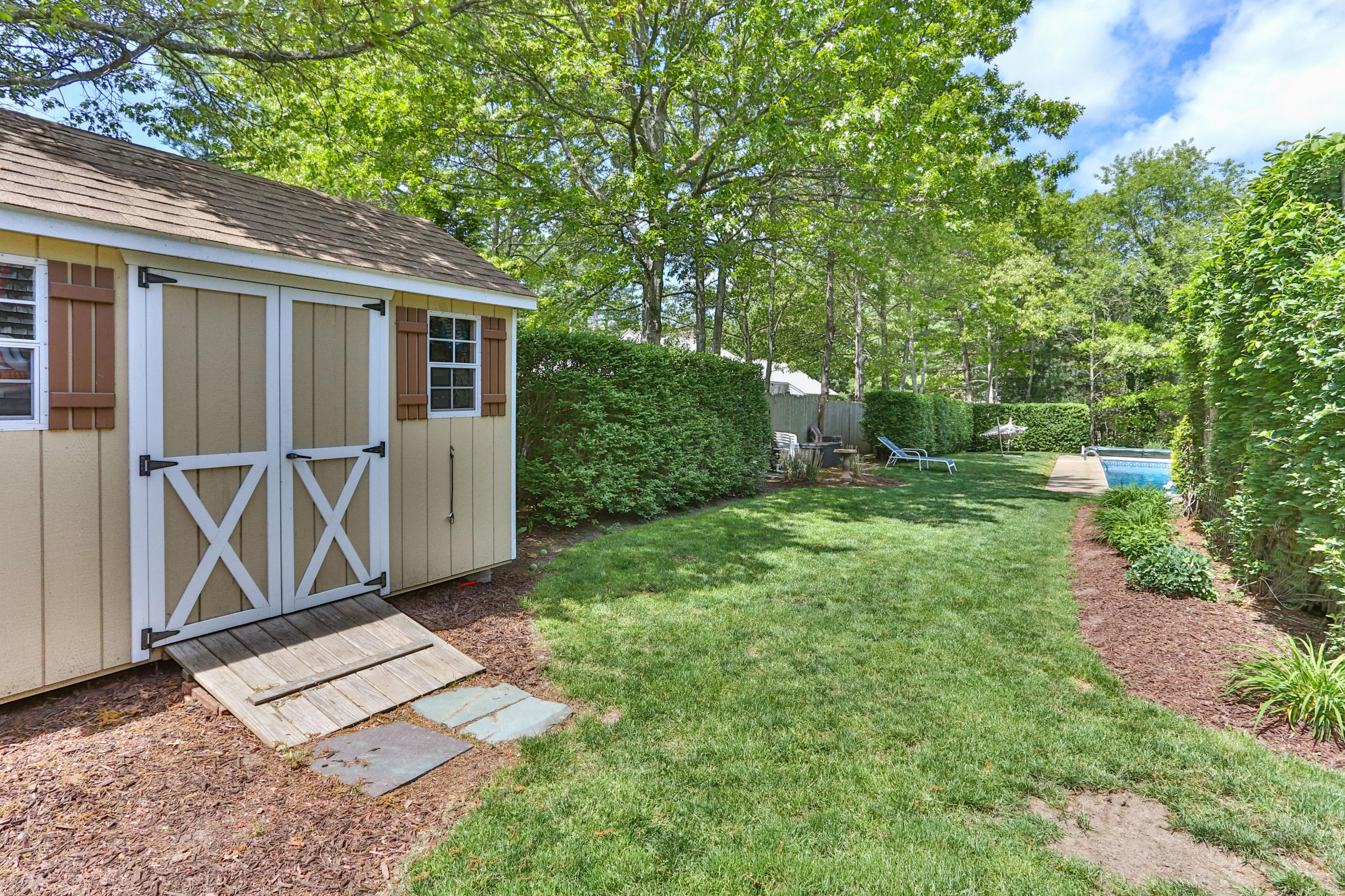 138 Gunstock Road Osterville, MA 02655 - Photo 41 of 47 a view of a house with a backyard