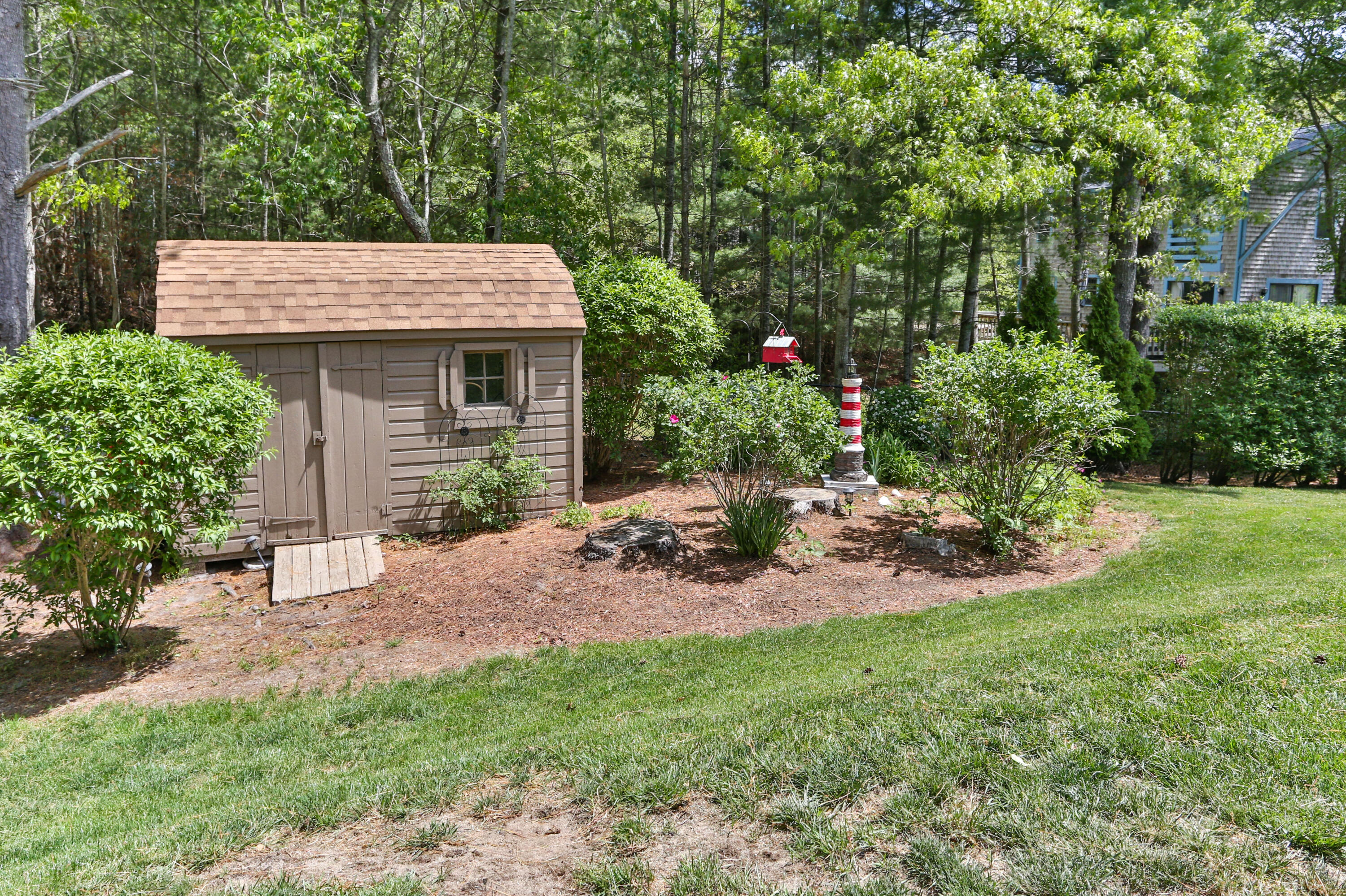 138 Gunstock Road Osterville, MA 02655 - Photo 42 of 47 a view of a backyard with a patio