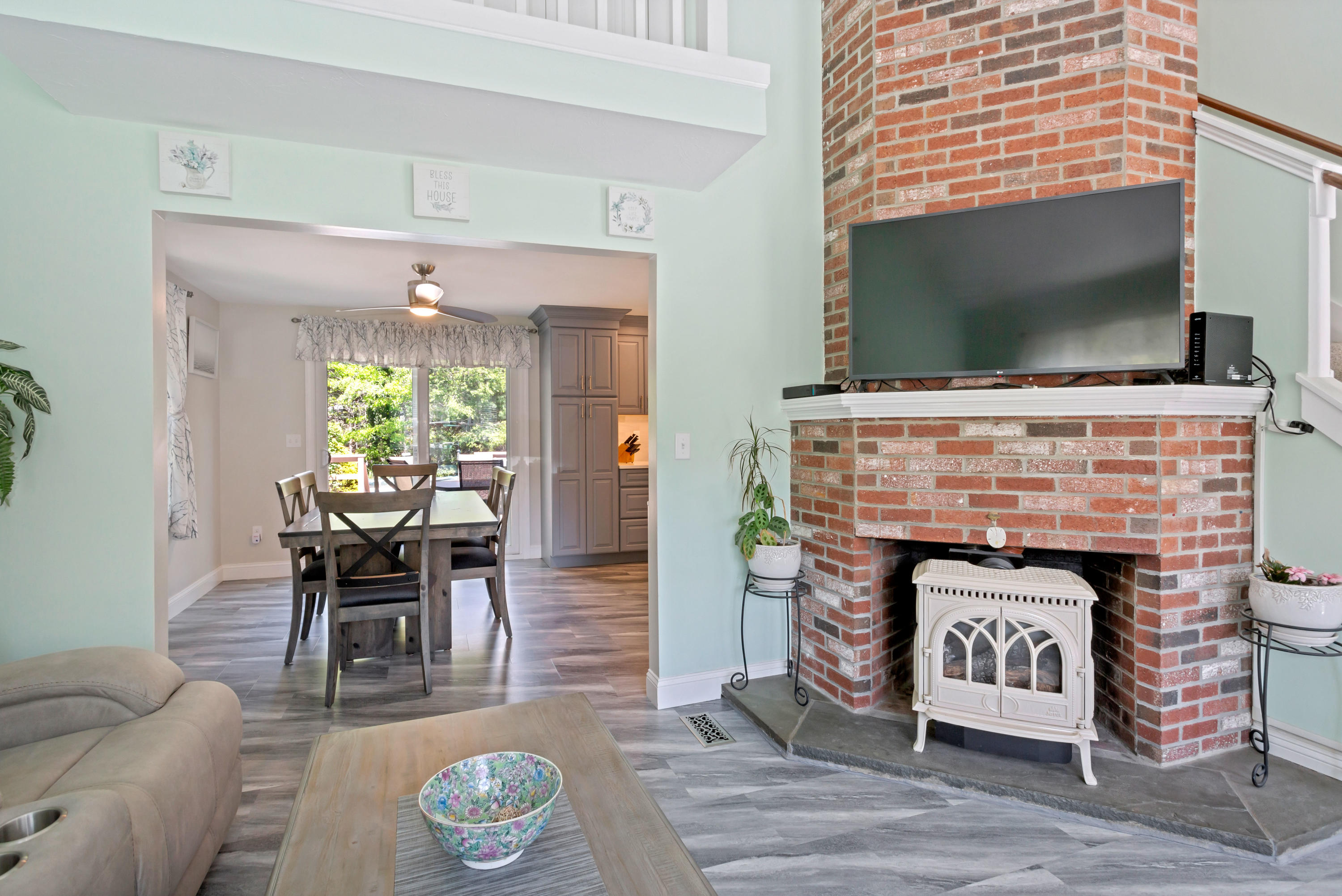 138 Gunstock Road Osterville, MA 02655 - Photo 7 of 47 a living room with furniture a flat screen tv and a fireplace