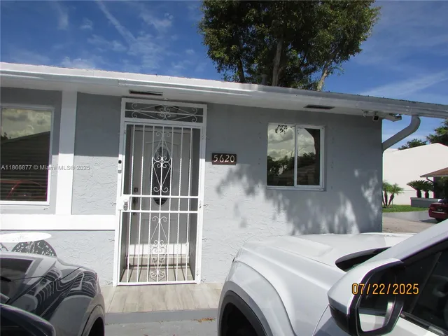 a view of a patio with a table and chairs