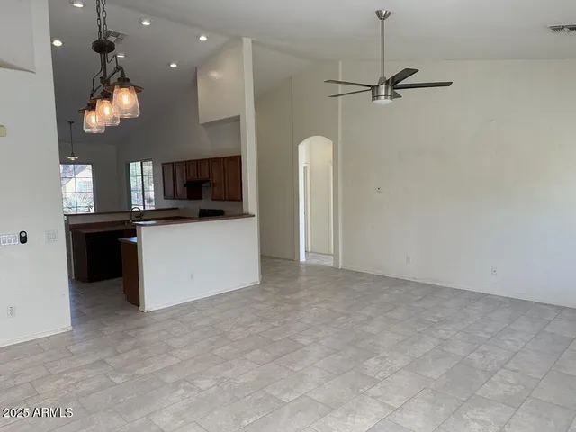 an empty room with windows and fireplace