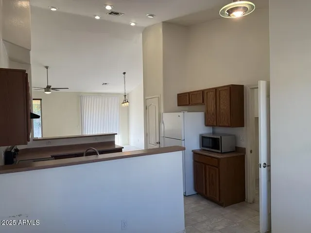 a kitchen with a refrigerator and a stove