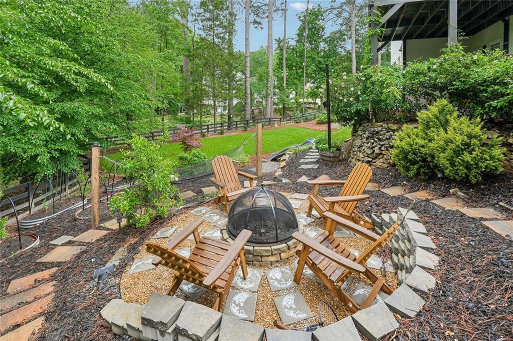 1091 Fieldstone Trail Milton, GA 30004 - Photo 71 of 84 a view of a patio with table and chairs potted plants with wooden floor and fence