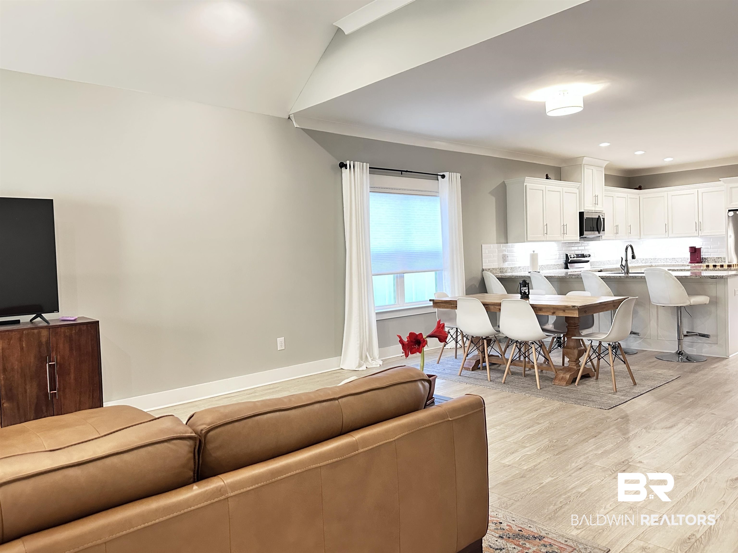 655 H Norman Lane Fairhope, AL 36532 - Photo 13 of 30 Living room featuring lofted ceiling, light wood-type flooring, and sink