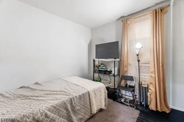 a bedroom with a bed and a mirror