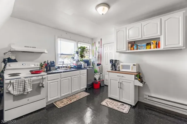 a kitchen with a sink cabinets and window