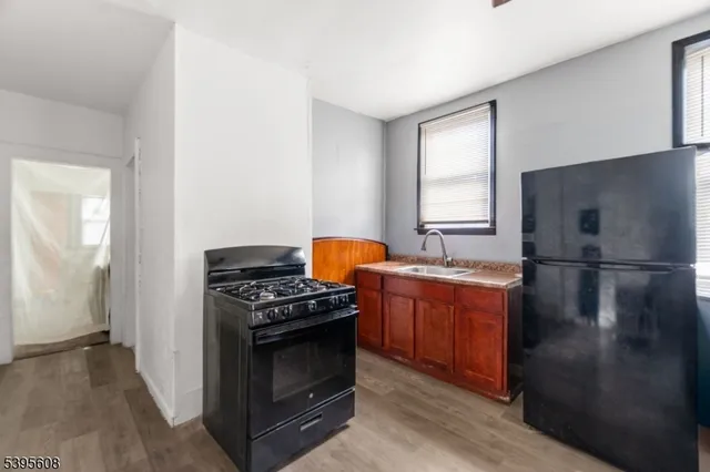 a kitchen with stainless steel appliances granite countertop a stove a refrigerator and a stove