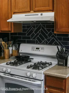 a stove top oven sitting inside of a kitchen